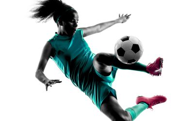 one teenager girl child  playing soccer player in silhouette isolated on white background