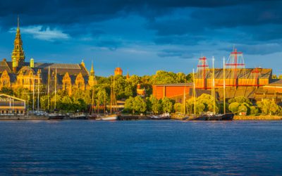 Stockholm, Sweden - July 7, 2016: Golden sunset light illuminating the iconic cultural centres of Djurgarden, from the Nordic Museum, past the Junibacken Children's Museum to the Vasa Museum and the Ladugardslandsviken harbour in the heart of Stockholm, Sweden's vibrant capital city. Composite panoramic image created from ten contemporaneous sequential photographs.